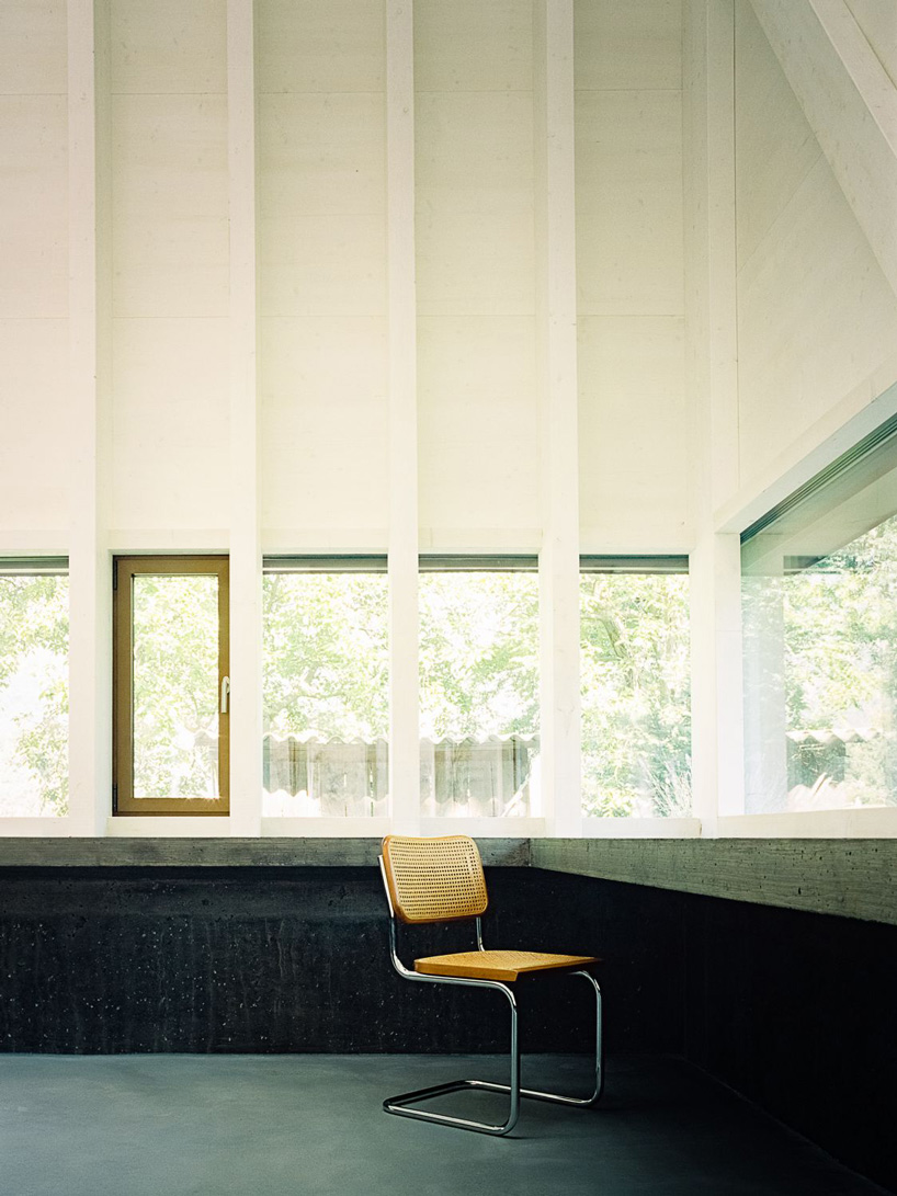 stocker lee architteti clads office building in switzerland in rust-red tiles + bricks