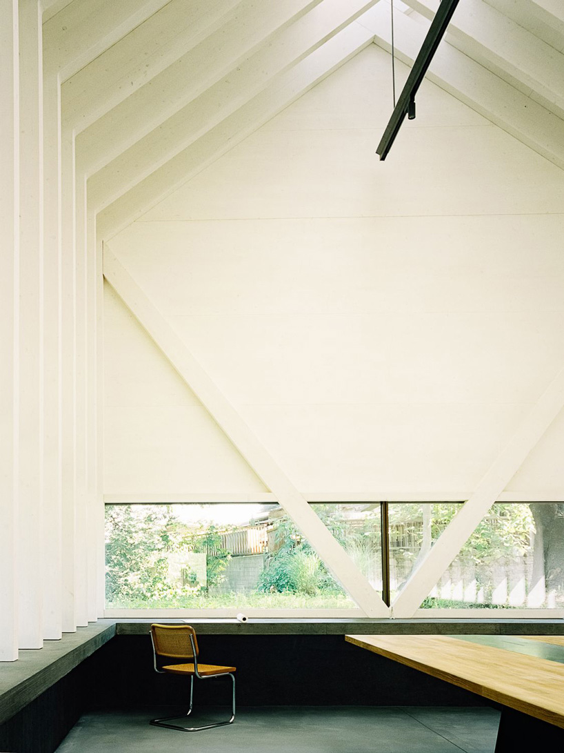 stocker lee architteti clads office building in switzerland in rust-red tiles + bricks