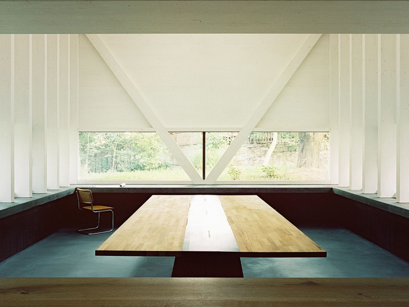 stocker lee architteti clads office building in switzerland in rust-red tiles + bricks