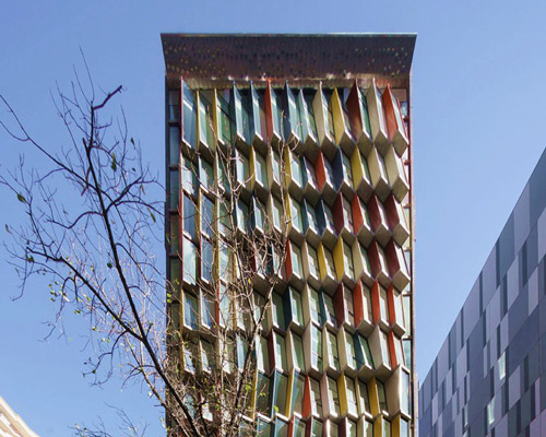tony owen partners clads apartment building with colorful mosaic windows in australia