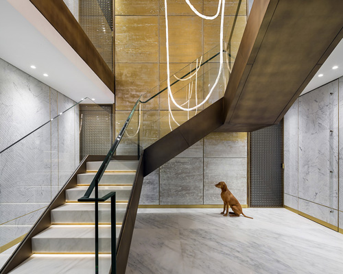 yoma architects clads luxury penthouse in marble and brass detailing in jerusalem