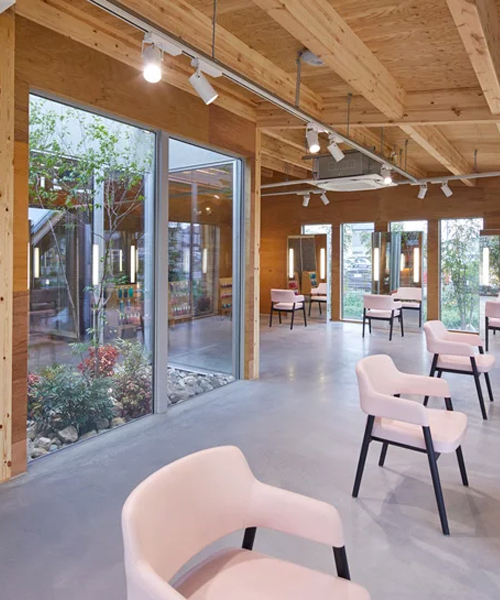 yoshihiro kato atelier folds roof to create façade of japanese hair salon