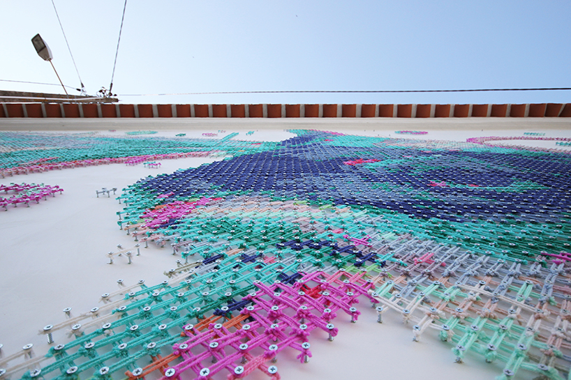 cross-stitch street art: portuguese artist combines digital and analog  design