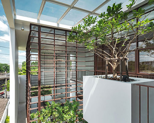 anonym studio merges indoor and outdoor space to create tree house in bangkok