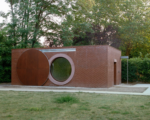 brick façades and circular windows define boman's archery house in france