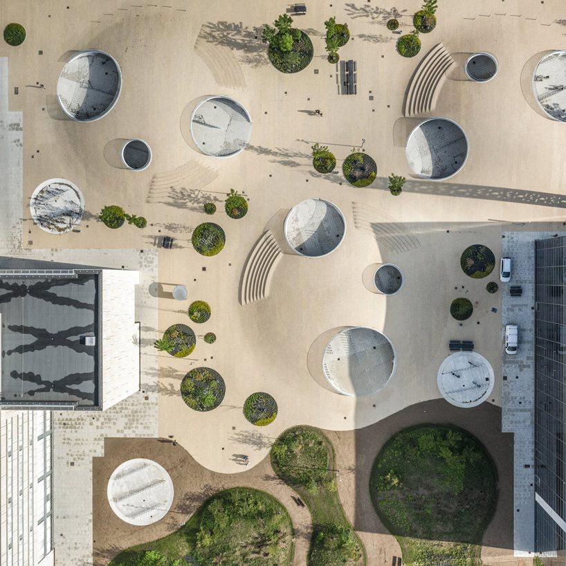 COBE architects’ karen blixens plads is an urban plaza of bicycle hills + plants in copenhagen