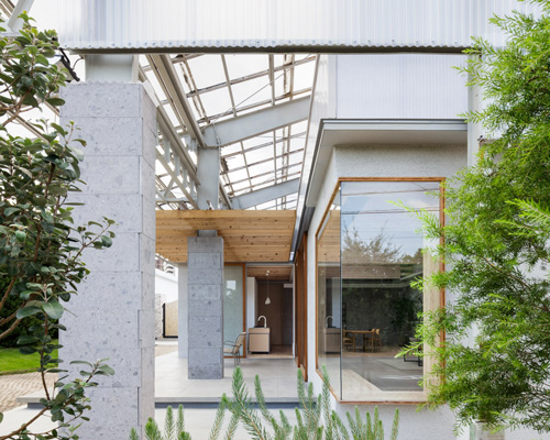 hiroki tominaga-atelier builds photo studio as wooden residence within a warehouse in japan
