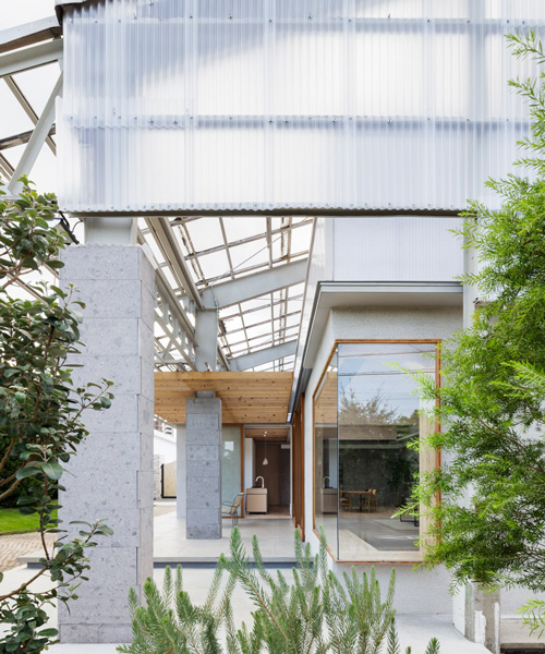hiroki tominaga-atelier builds photo studio as wooden residence within a warehouse in japan