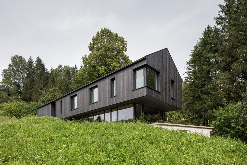 sigurd larsen wraps cantilevering mountain house in austria in mirrored glass + timber