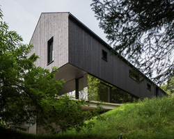 sigurd larsen wraps cantilevering mountain house in austria in mirrored glass + timber