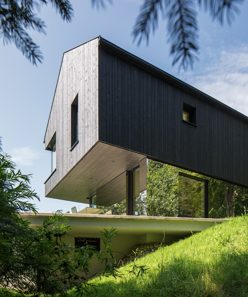 sigurd larsen wraps cantilevering mountain house in austria in mirrored glass + timber