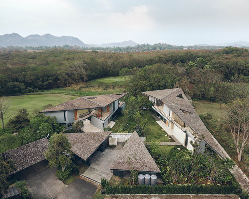 Stu/D/O architects tops houses of the gliding villa in thailand with triangular roofs