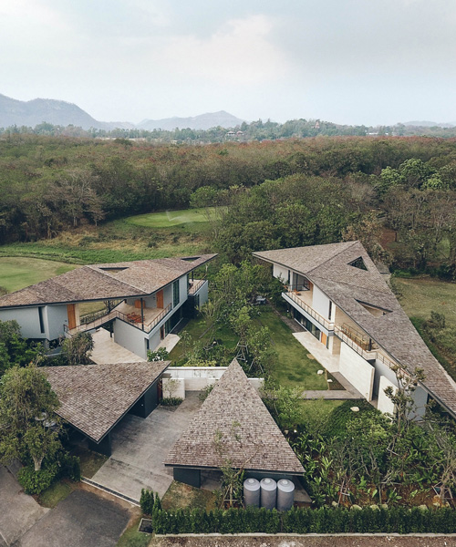 Stu/D/O architects tops houses of the gliding villa in thailand with triangular roofs
