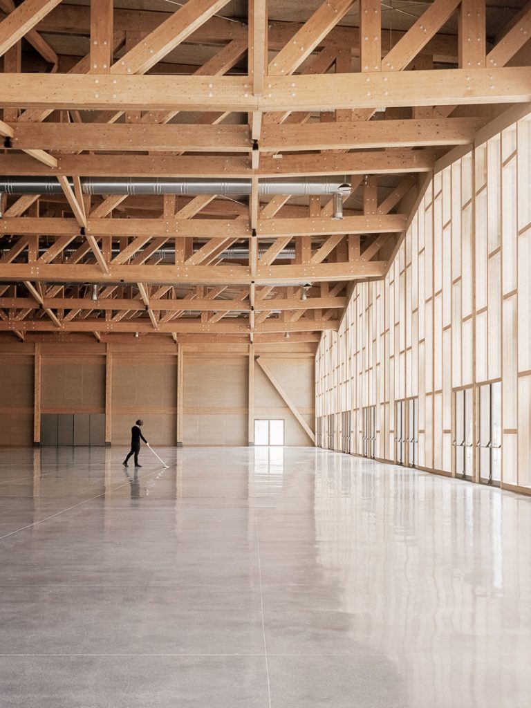 rhythmic timber structure punctuates the vast northern italian landscape