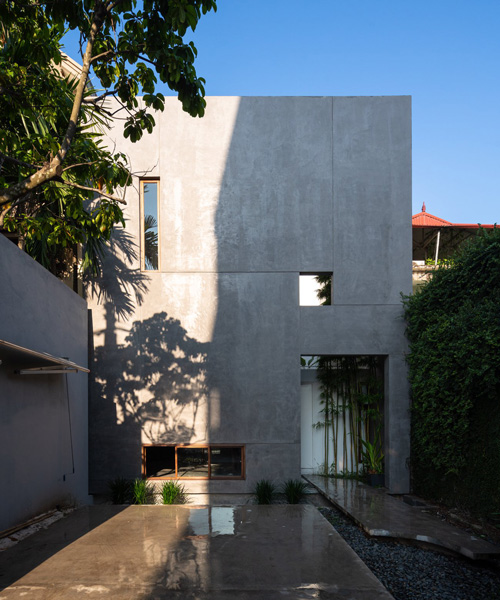AHL encloses the living areas + courtyards of 8x24 house in vietnam using a concrete shell