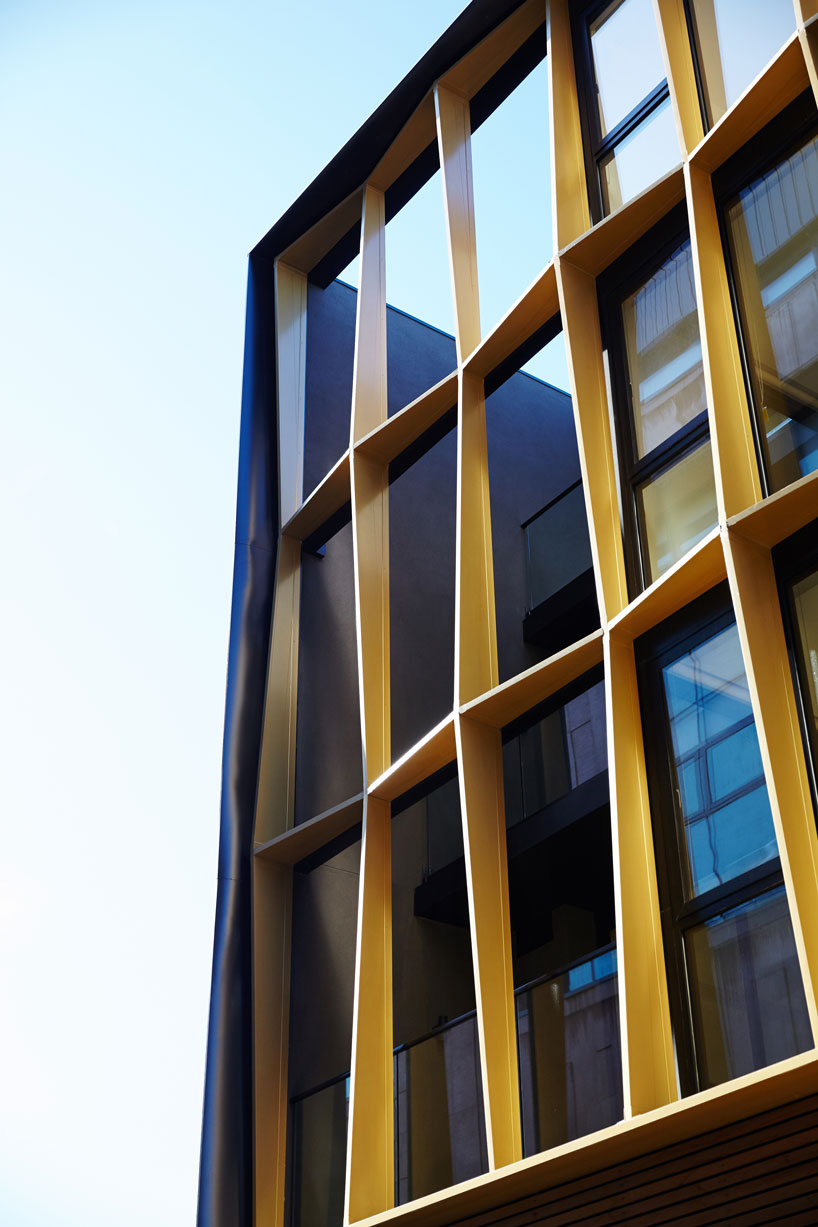 DROO frames burwood road apartment facade with faceted golden fins