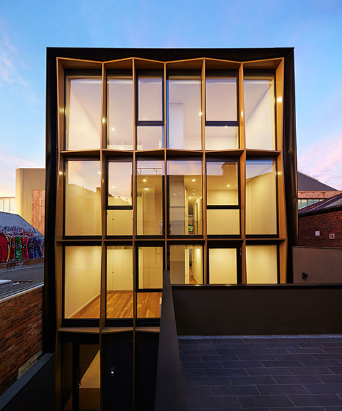 DROO frames burwood road apartment facade with faceted golden fins