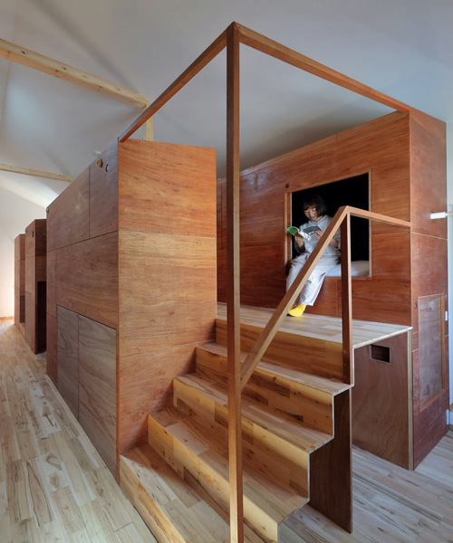 alphaville designs capsule hostel 'sui' in kyoto as cluster of wooden volumes