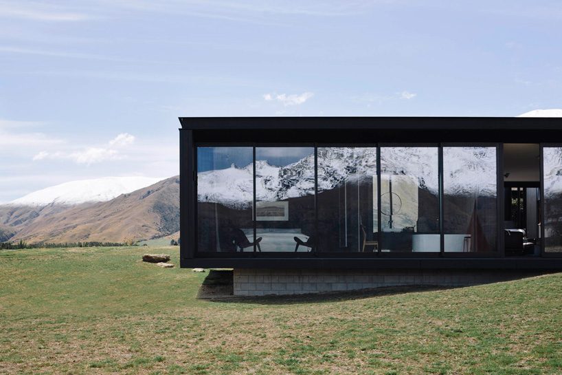 fearon hay architects builds house in new zealand's alps as cluster of blackened volumes