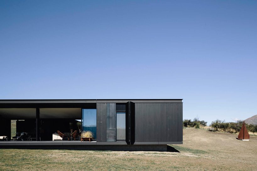 fearon hay architects builds house in new zealand's alps as cluster of blackened volumes