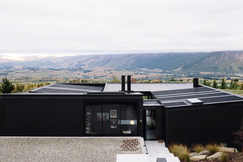 fearon hay architects builds house in new zealand's alps as cluster of blackened volumes