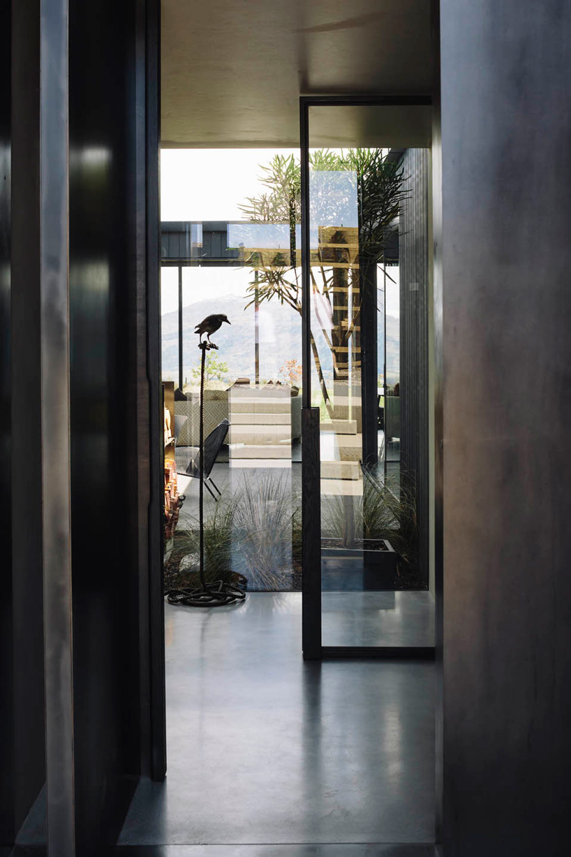 fearon hay architects builds house in new zealand's alps as cluster of blackened volumes