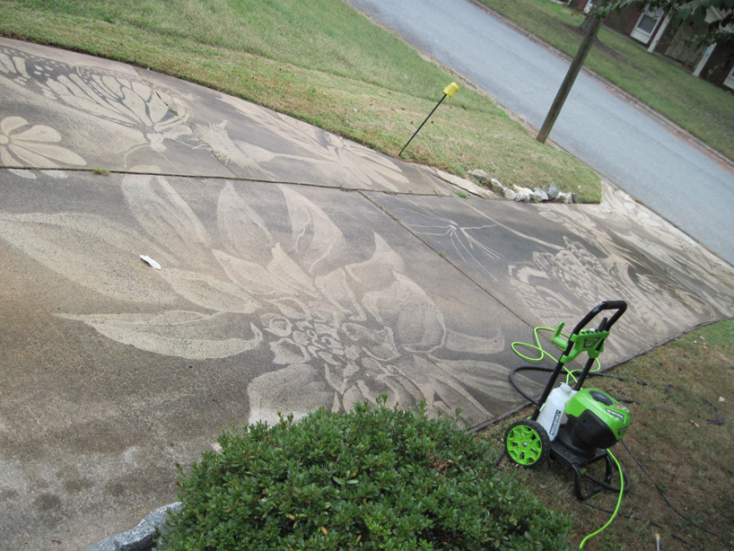 dianna wood uses power washer to create art on her dirty driveway