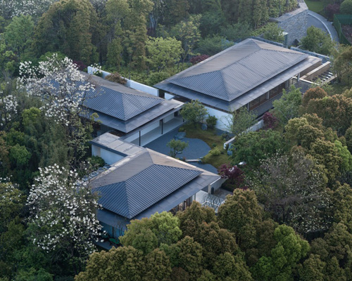 living center by hangzhou 9M architectural design co. blends into the hills of rural china