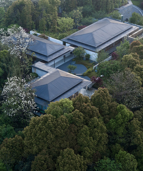 living center by hangzhou 9M architectural design co. blends into the hills of rural china