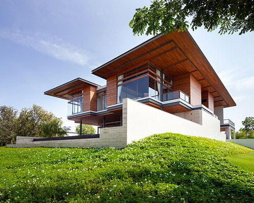 junsekino combines wooden cantilevers with exposed steel for contemporary home in bangkok