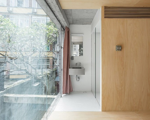 kooo architects adds wooden finish to exposed concrete interiors in chinese guesthouse