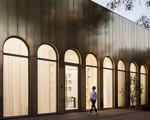 golden metal panels clad WALL's apartment complex showroom in moscow 