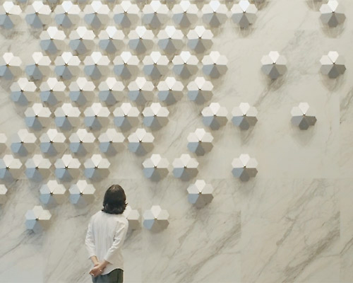 whyixd hangs 140 metal flowers that move to the music on a taiwan building lobby