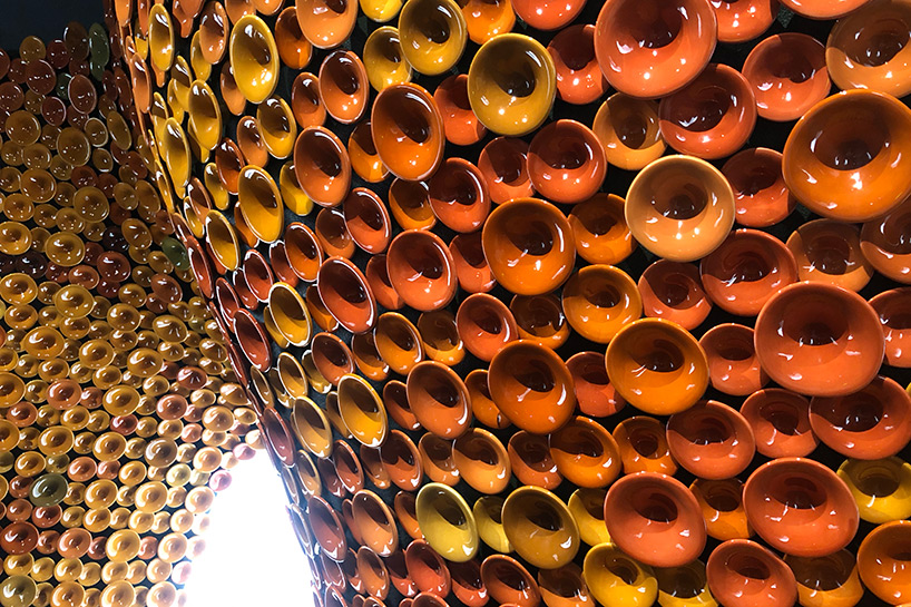 metamorphosis: andrea mancuso creates cavernous, ceramic-clad installation for perrier-jouët