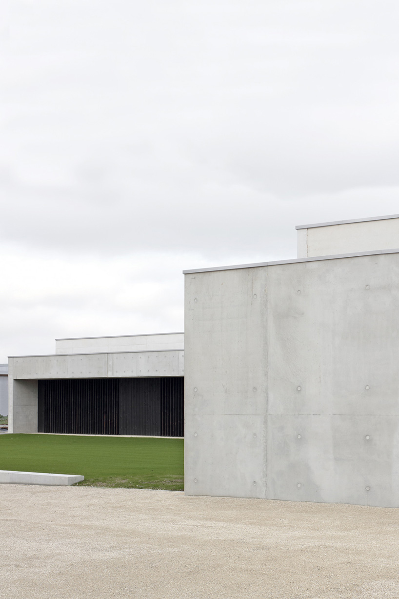  A6A combines white concrete + charred wood for les patios health center in france