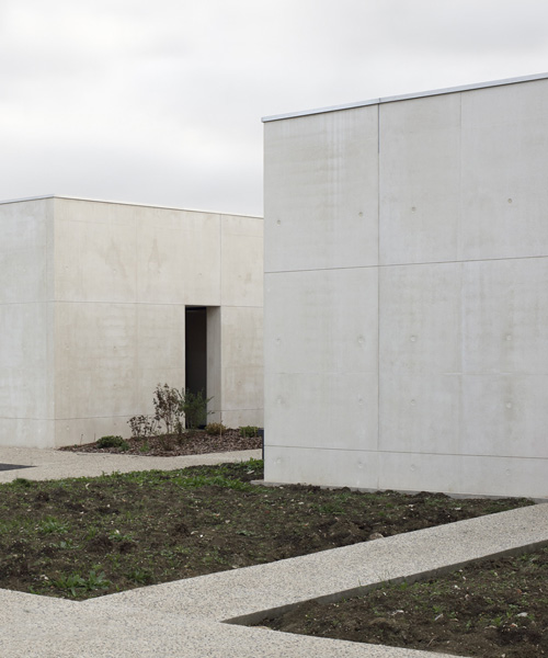 A6A combines white concrete + charred wood for les patios health center in france