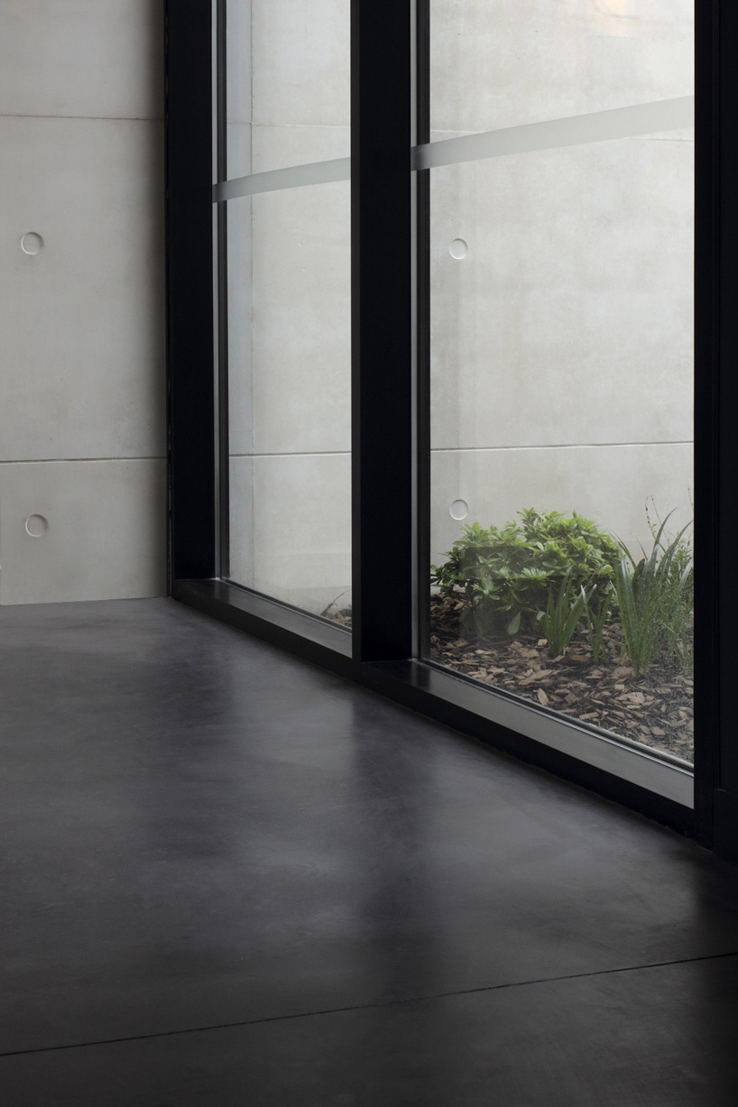 A6A combines white concrete + charred wood for les patios health center in france