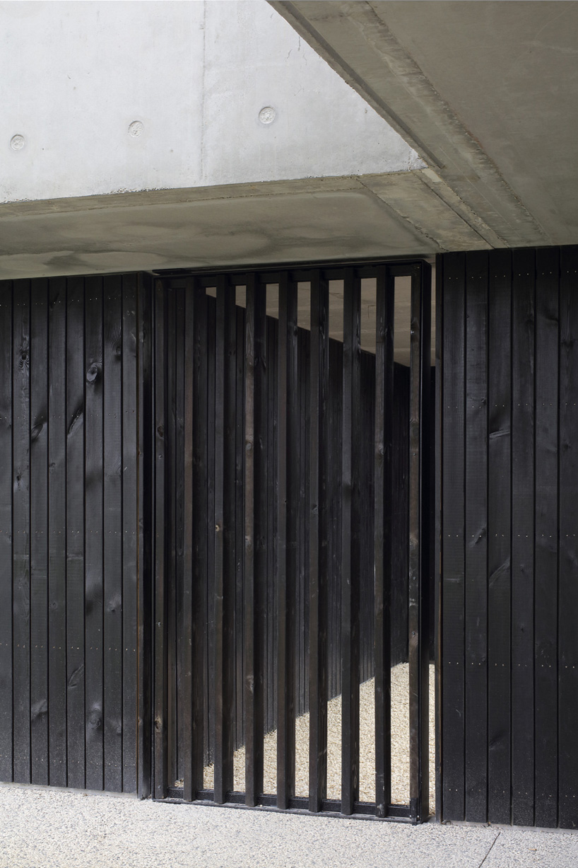 A6A combines white concrete + charred wood for les patios health center in france