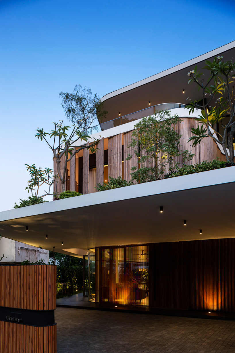 wallflower wraps house in singapore in a bamboo veil of operable screens