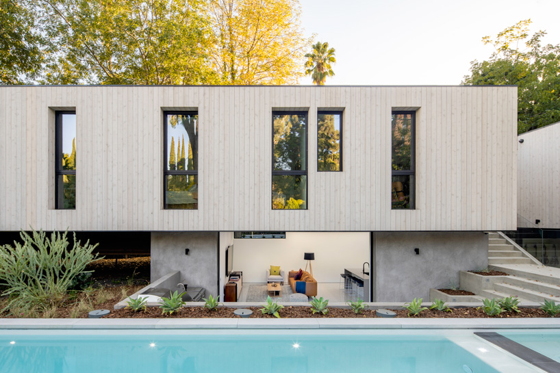 DBA's bridge house stretches 60 meters over a natural stream in los angeles