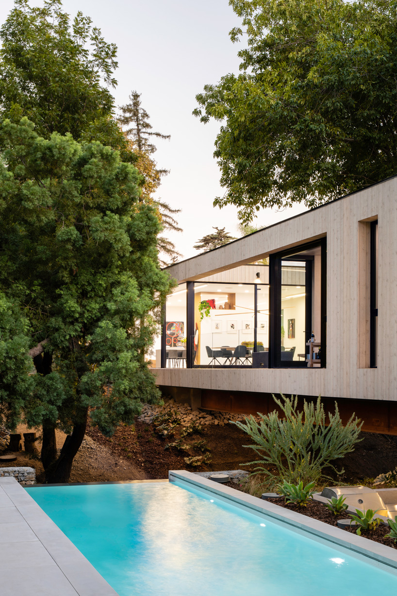 DBA's bridge house stretches 60 meters over a natural stream in los angeles