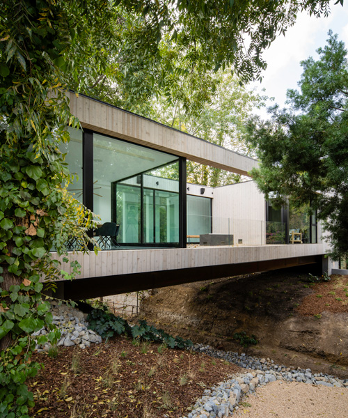 DBA's bridge house stretches 60 meters over a natural stream in los angeles