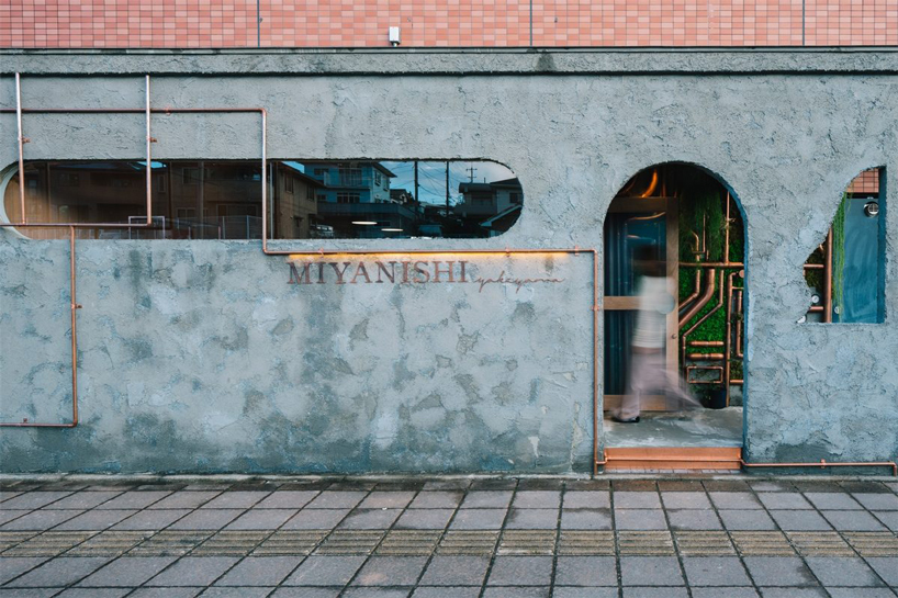 fathom finishes miyanishi yakeyama hair salon in japan with wall of greenery + copper pipes