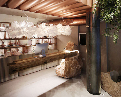 pastel pinks and massive stones fill molos group's design of a beauty salon in kosovo