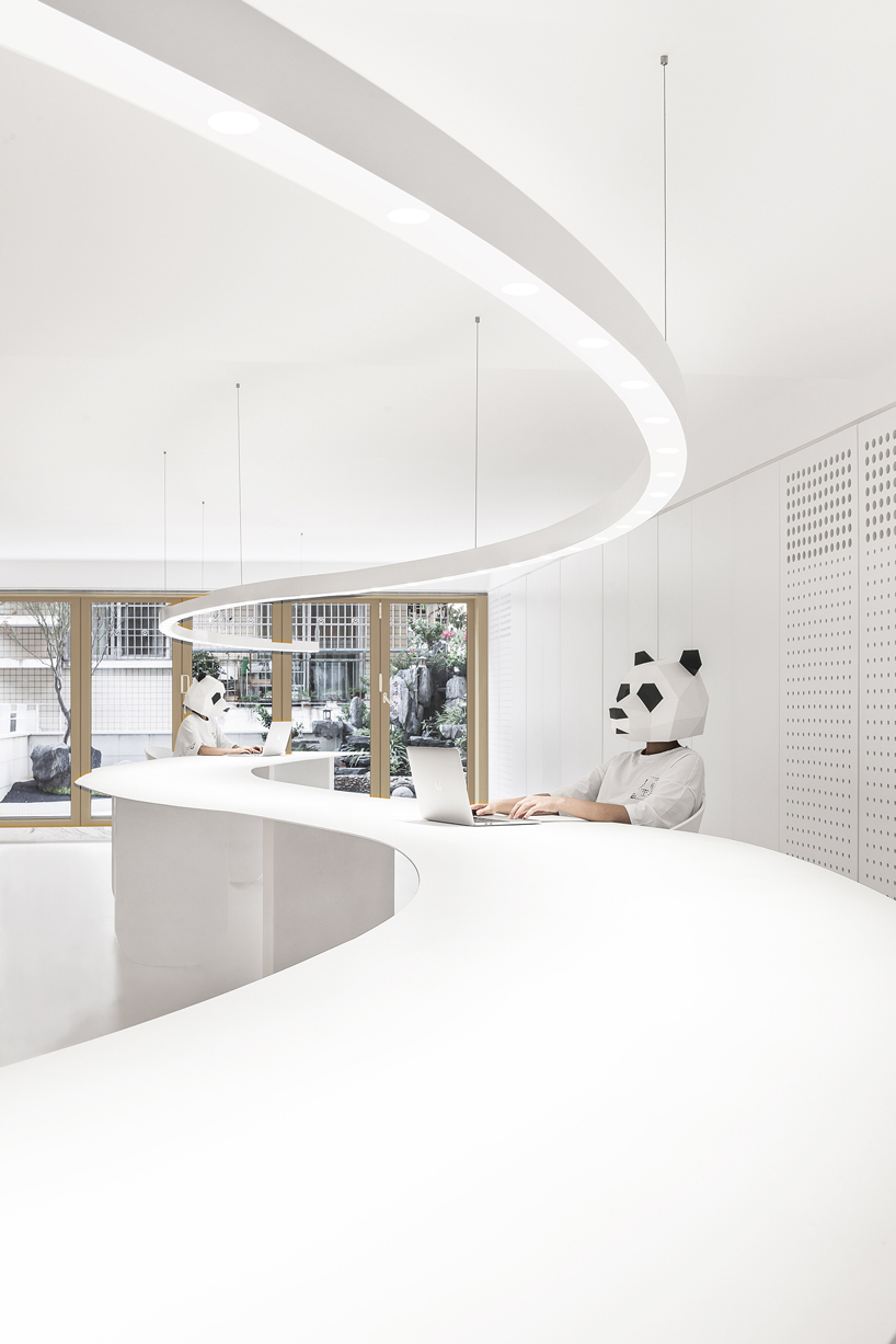 panda design builds a new office around a curved workspace in xiamen, china designboom