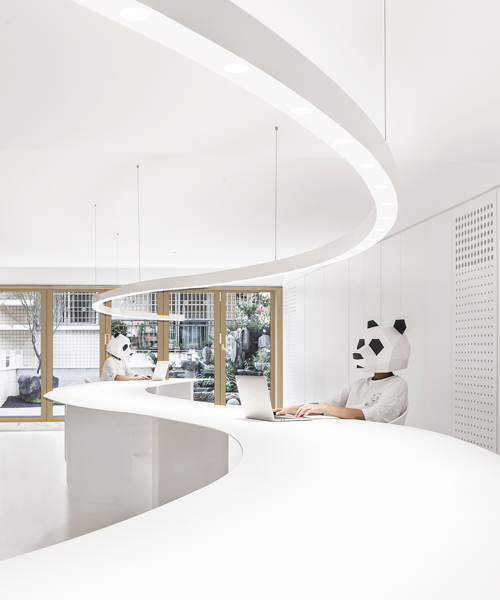 panda design builds a new office around a curved workspace in xiamen, china
