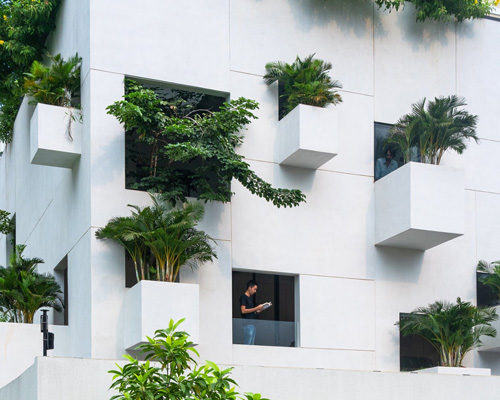 MIA design studio clads vietnamese house in façade of extruded planters + openings