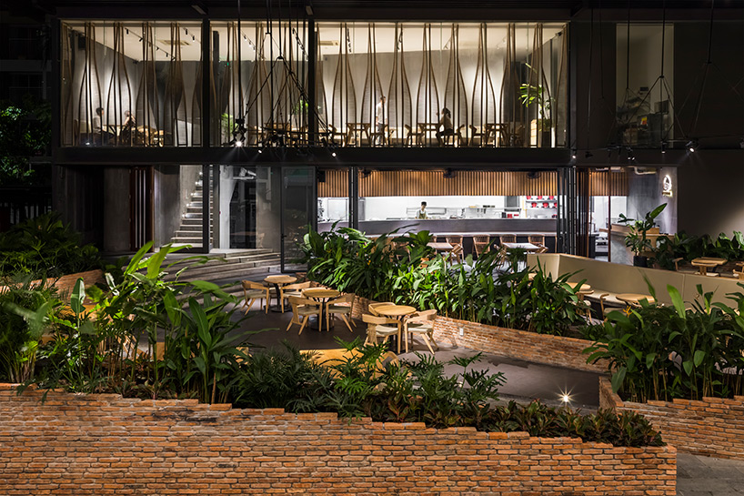 chopstick screens and greenery form both social and private spaces for ippudo vietnam