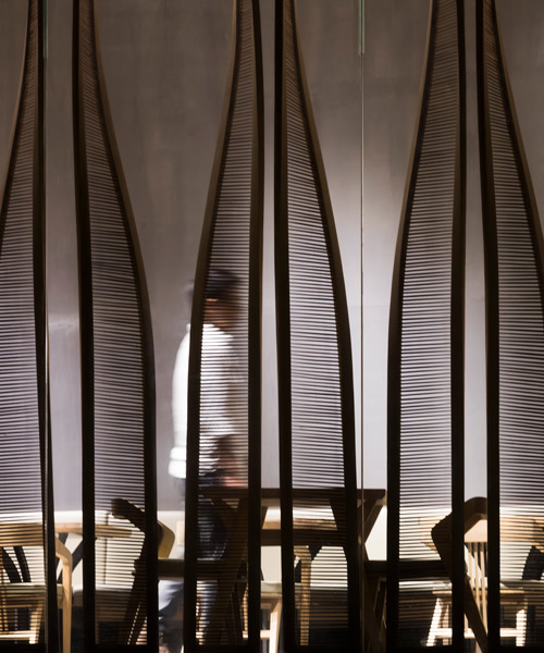 chopstick screens and greenery form both social and private spaces for ippudo vietnam