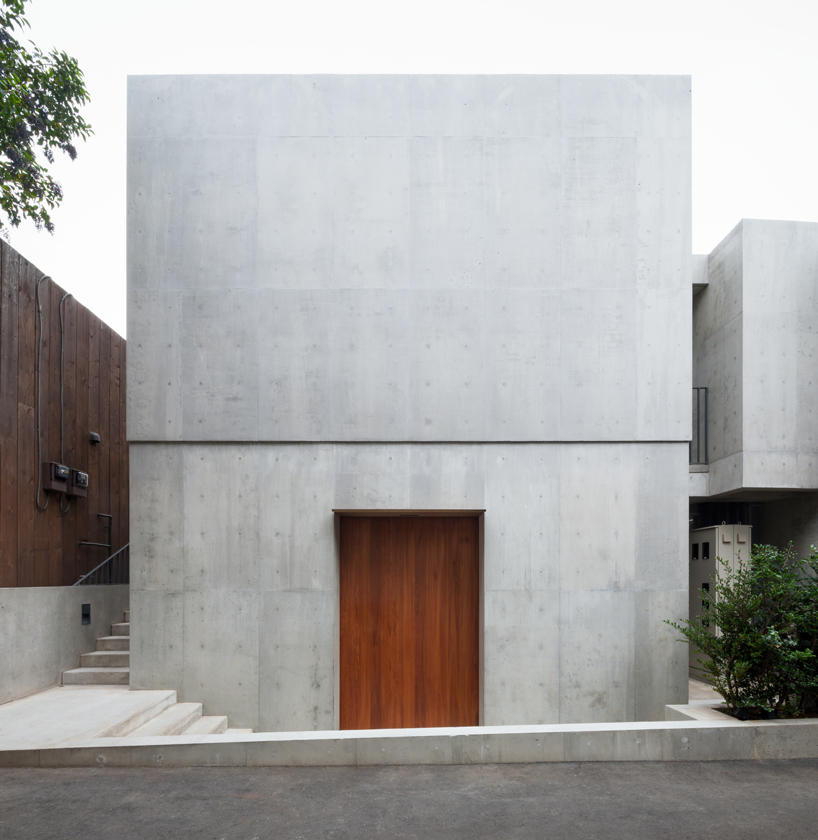 nobuo araki combines three concrete blocks in the mass museum in tokyo